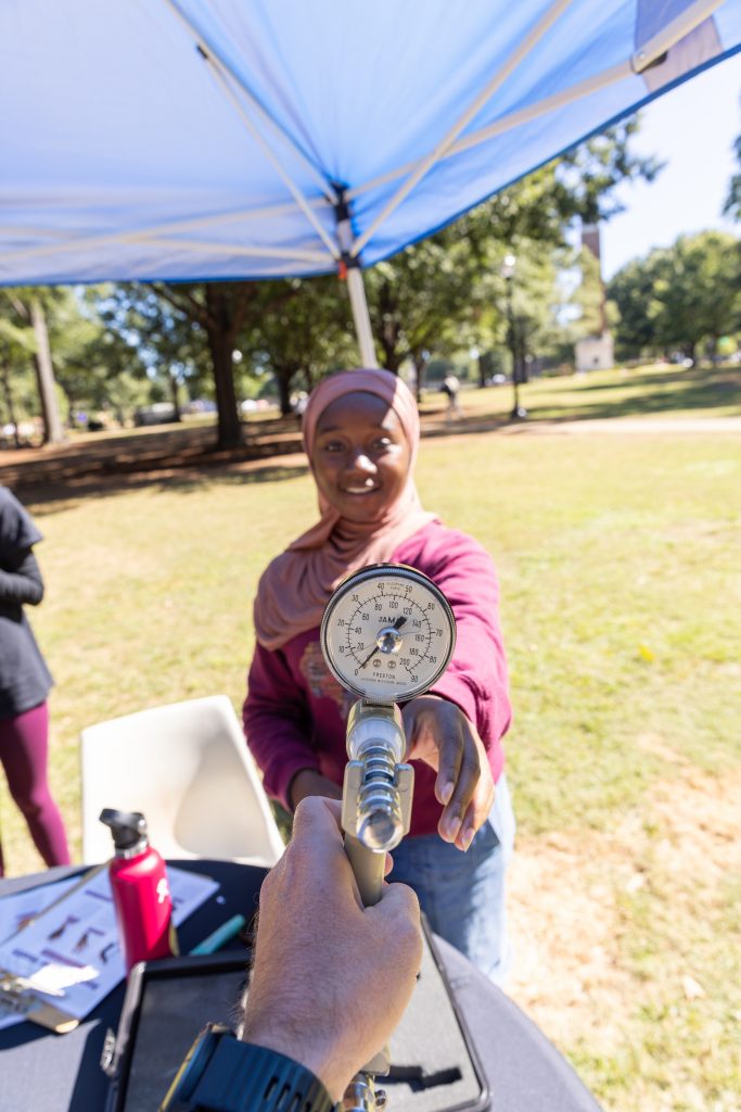 Person reaching out for a grip strength meter