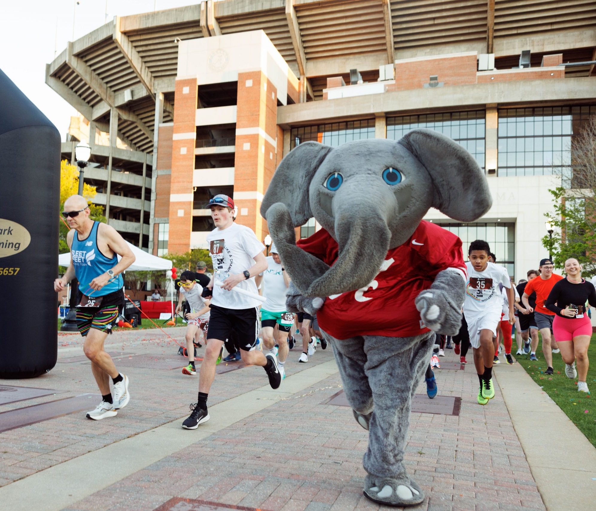 Big Al (elephant mascot) outside Bryant-Denny stadium running a 5k with other event participants