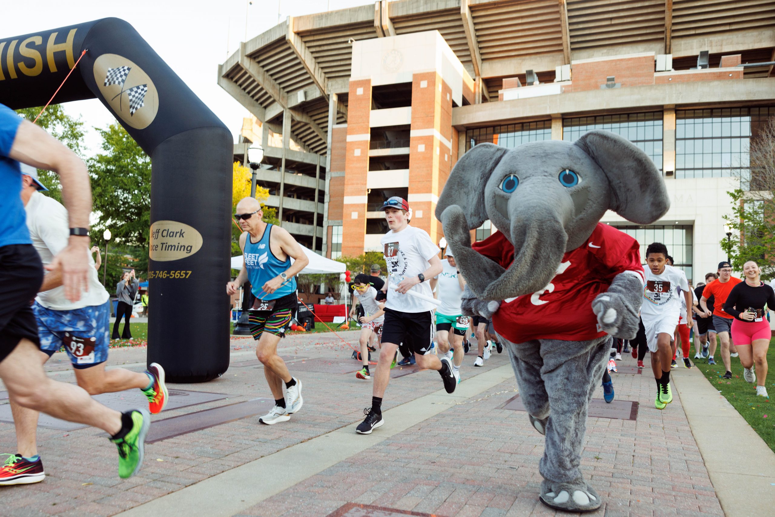 Big Al (elephant mascot) outside Bryant-Denny stadium running a 5k with other event participants