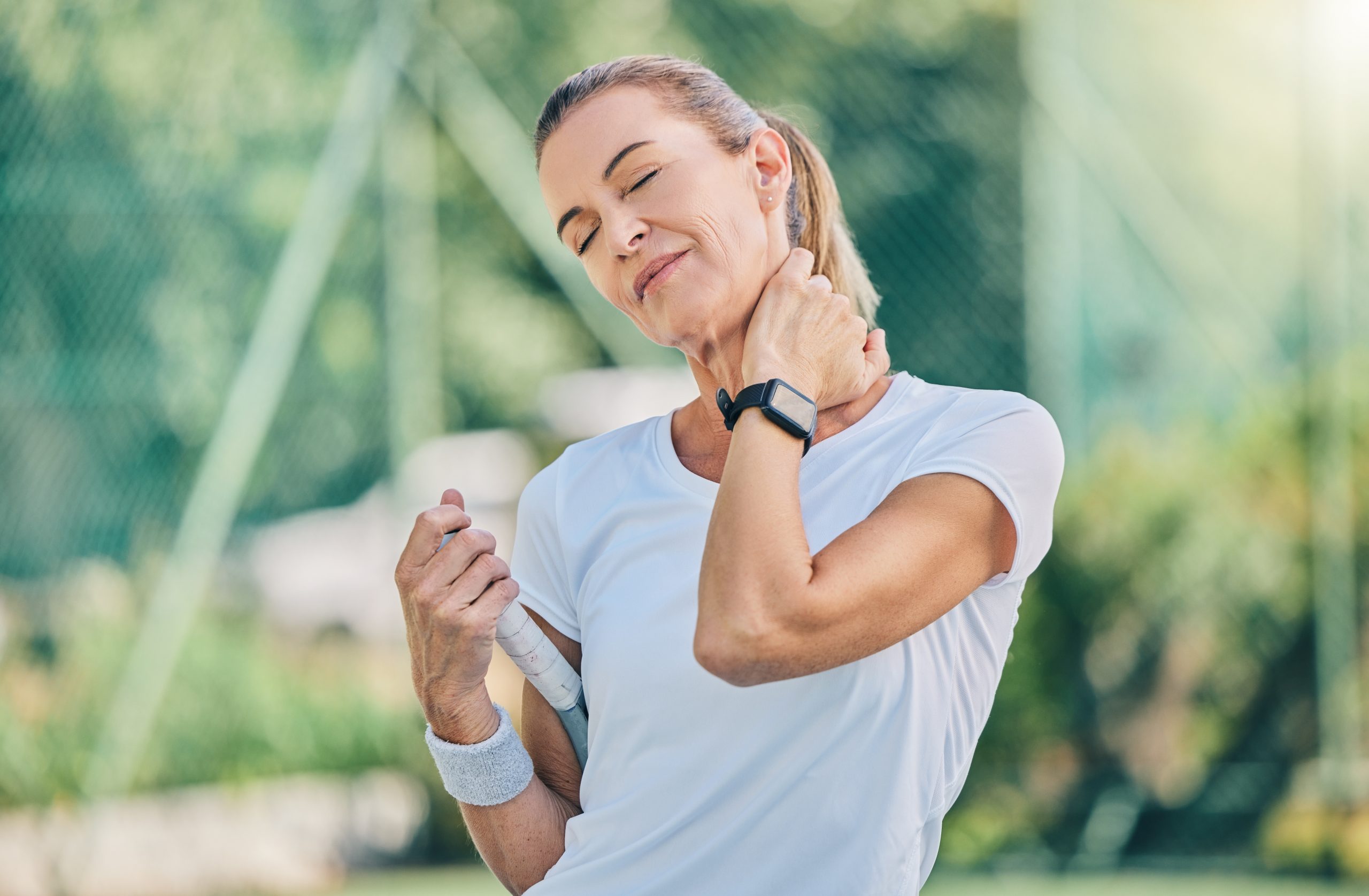 Fitness, neck pain and tennis training with a mature woman on a outdoor court with mockup and injury. Sports, wellness and workout inflammation of a athlete with joint and muscle problem from sport.