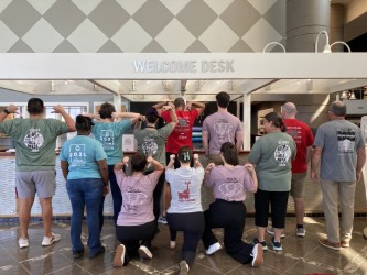 Group of UA employees wearing their various WellBAMA t-shirts