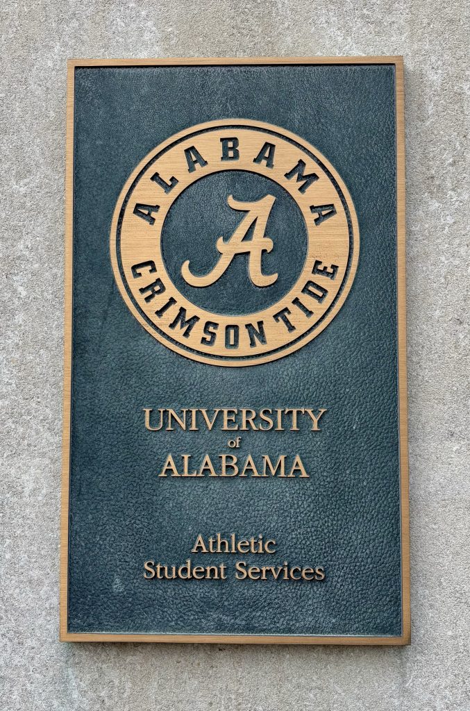 Plaque that reads: "Alabama Crimson Tide. University of Alabama Athletic Student Services"