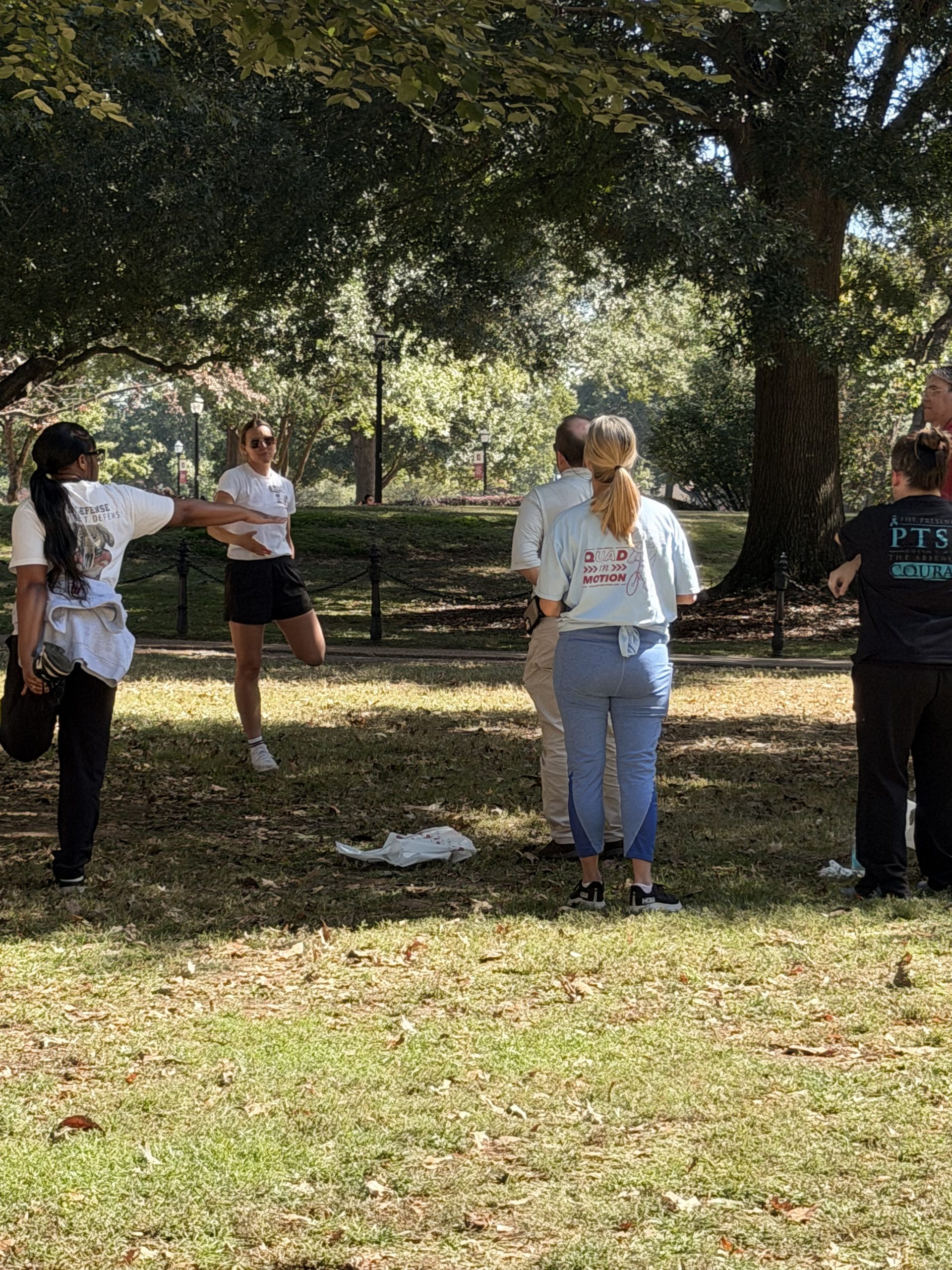 a group of people stand in a circle while doing stretches they can do in their office