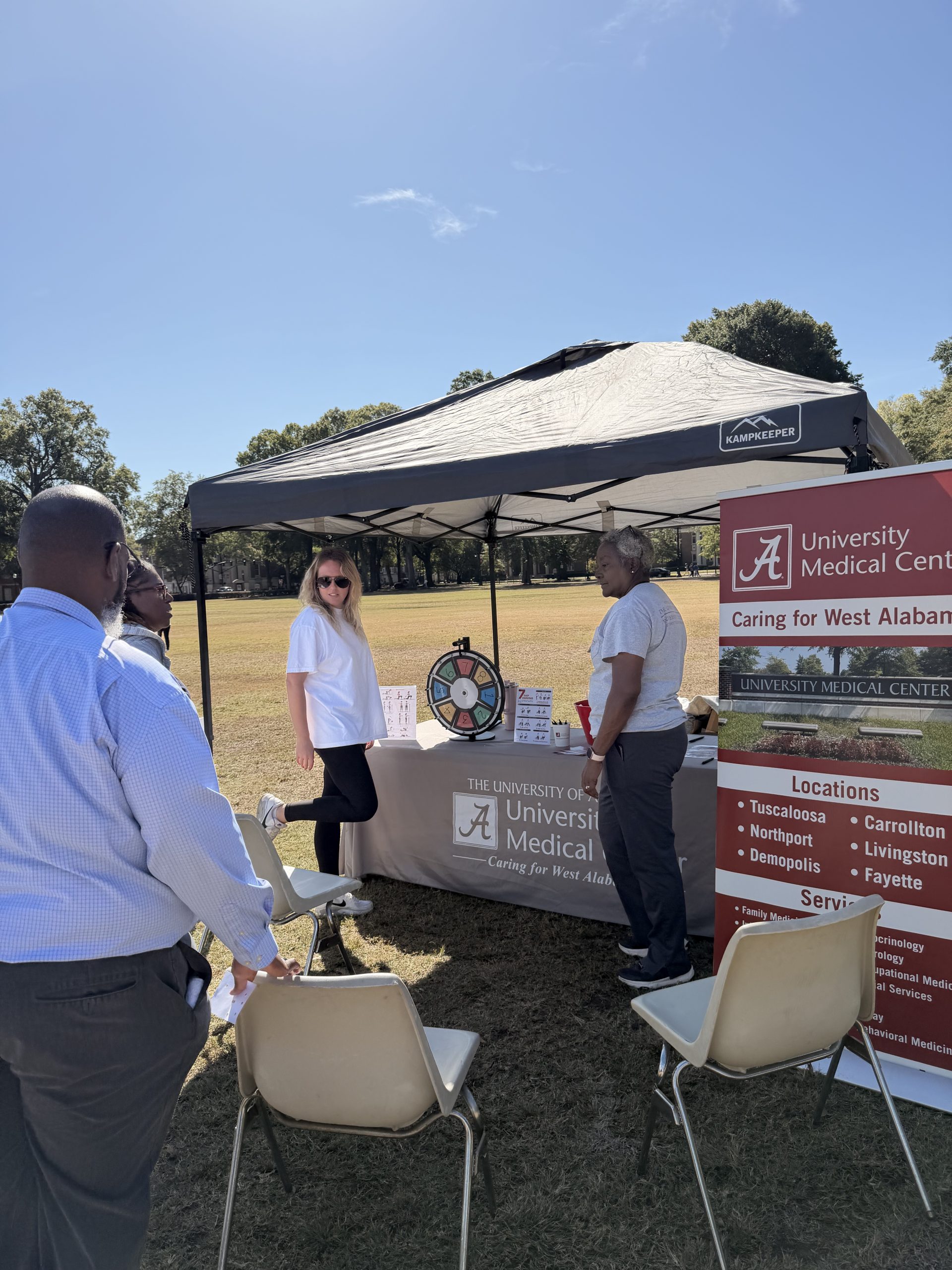 2 women lead stretches while participants hold on to the back of chairs for balance